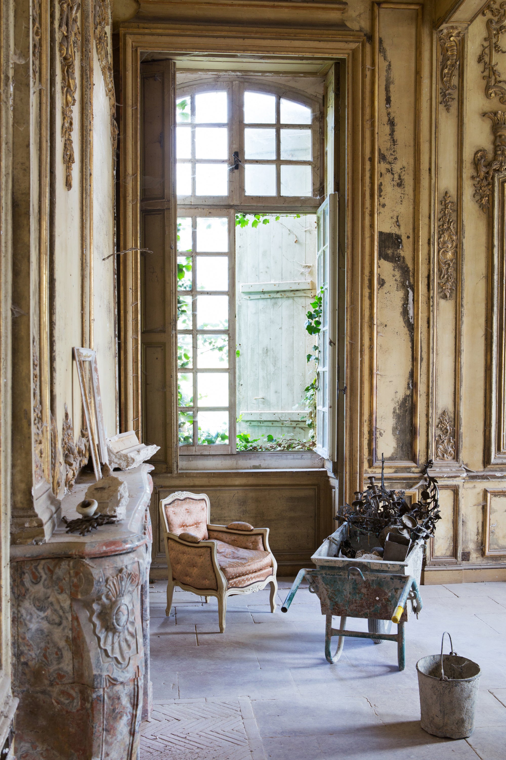 Vintage room with ornate walls, a large window, and antique furniture — photography by Carla Coulson